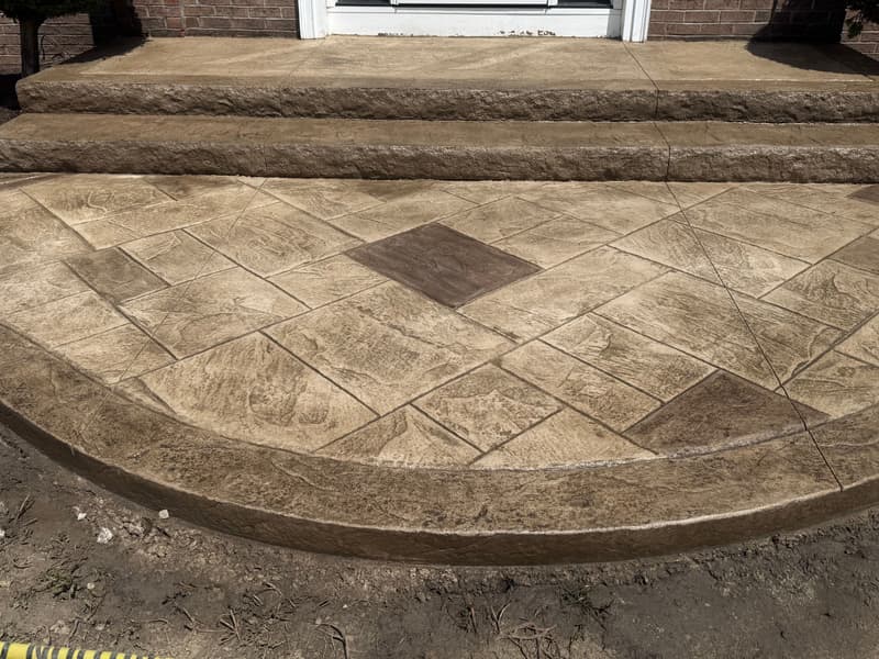 Tan stamped stone with an accent tile and border